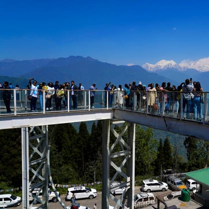 Visitors on the Pelling Sky Walk beside the Chenrezig statue